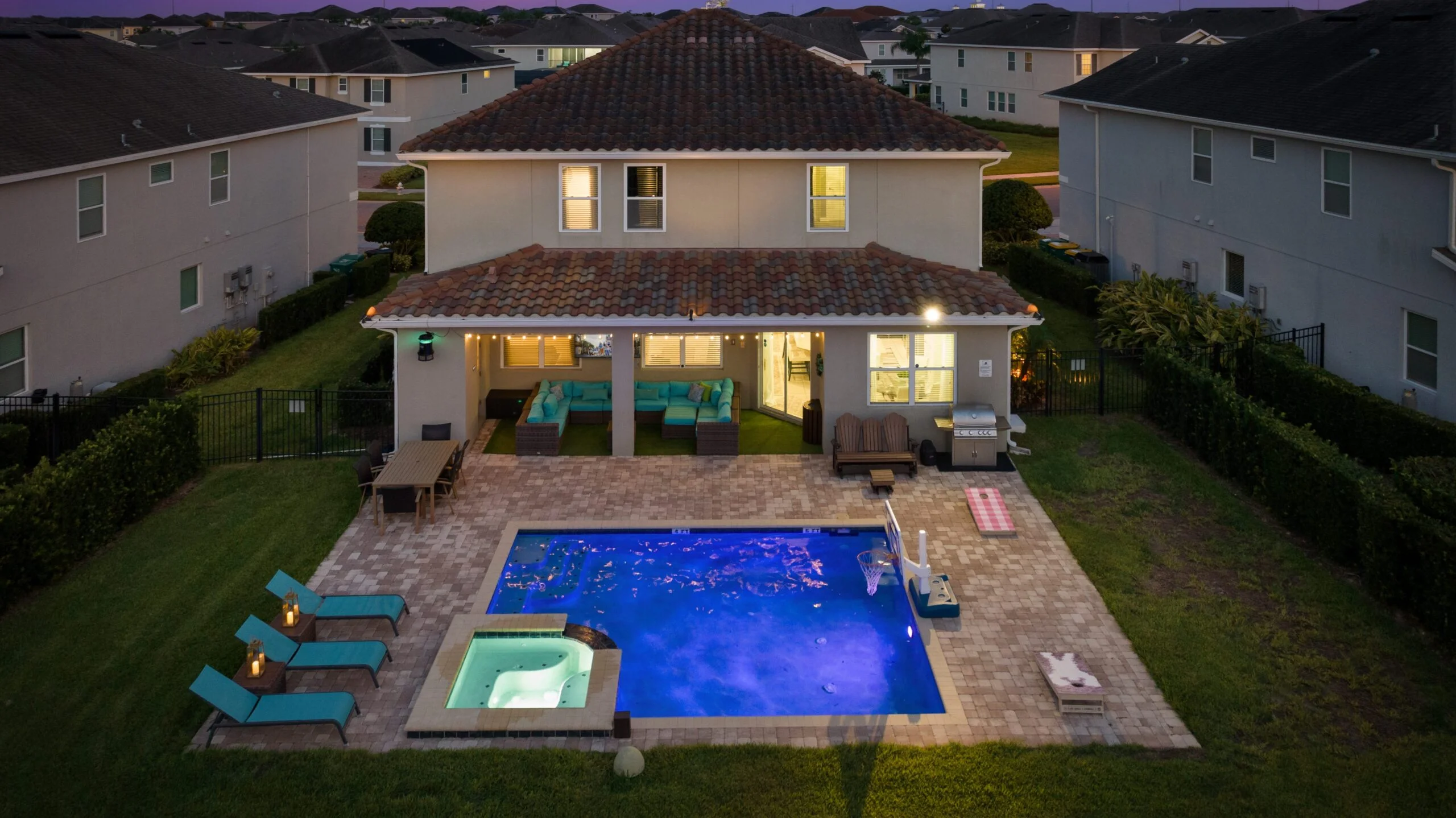 Backyard pool area lit up at night at 450 Burma vacation home