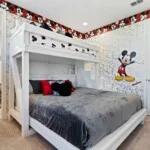 Mickey Mouse bedroom with king bed and bunk beds at 450 Burma vacation rental