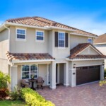 Front yard with tropical palm trees at 450 Burma in Encore at Reunion West