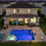 Backyard pool area lit up at night at 450 Burma vacation home